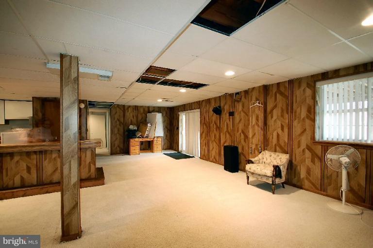 a view of a livingroom with furniture and a large window