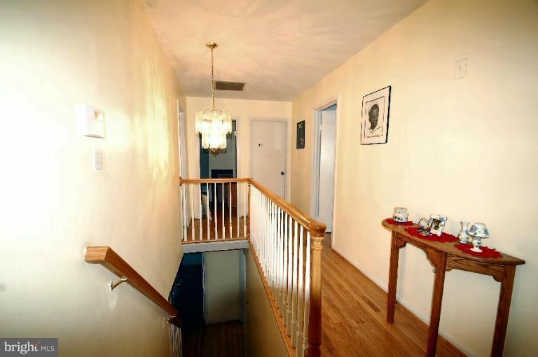 2314 Falling Creek Road Silver Spring, MD 20904 - Photo 14 of 16 a view of a hallway with wooden floor and stairs