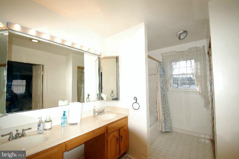 2314 Falling Creek Road Silver Spring, MD 20904 - Photo 8 of 16 a bathroom with a sink double vanity and a mirror