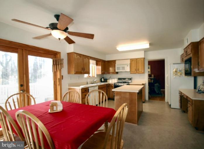 2314 Falling Creek Road Silver Spring, MD 20904 - Photo 9 of 16 a view of a dining room with furniture a kitchen and chandelier