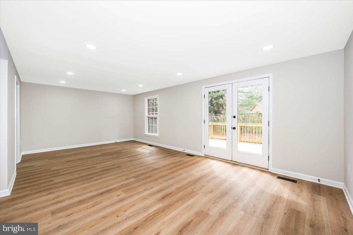 8200 Red Wing Court Frederick, MD 21701 - Photo 11 of 40 a view of an empty room with wooden floor and a window
