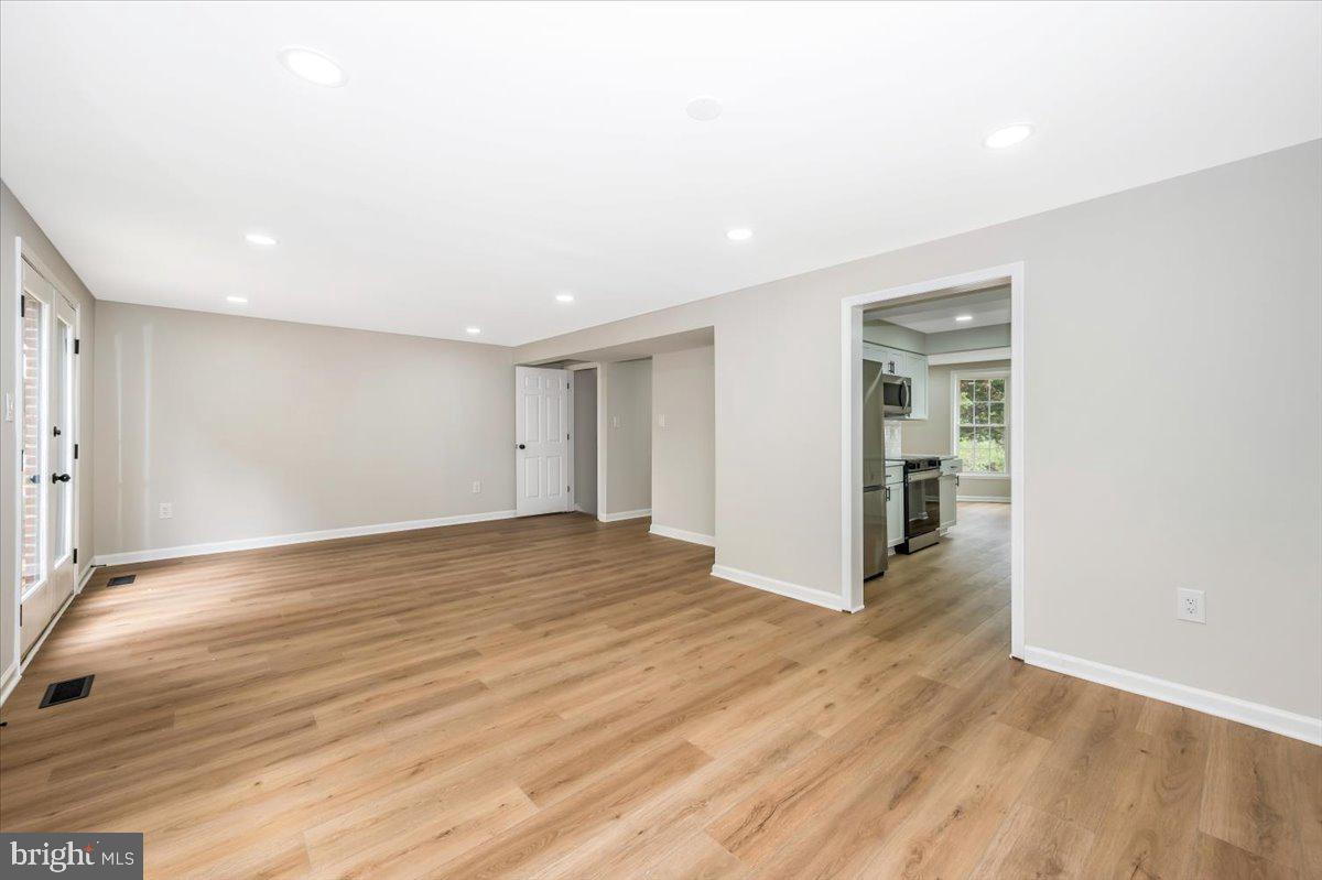 8200 Red Wing Court Frederick, MD 21701 - Photo 13 of 40 a view of an empty room with wooden floor and a window