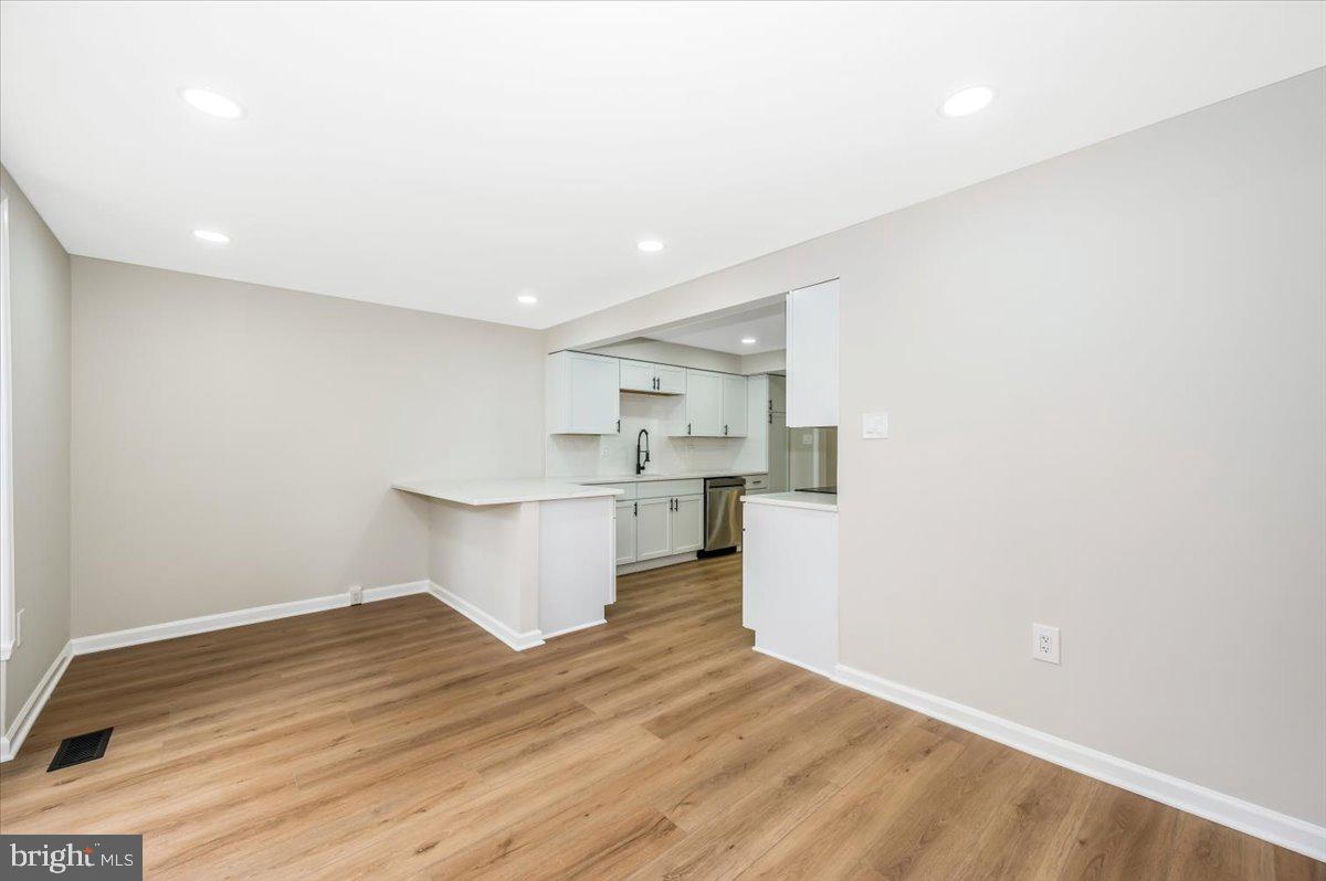 8200 Red Wing Court Frederick, MD 21701 - Photo 3 of 40 a view of kitchen and empty room with wooden floor