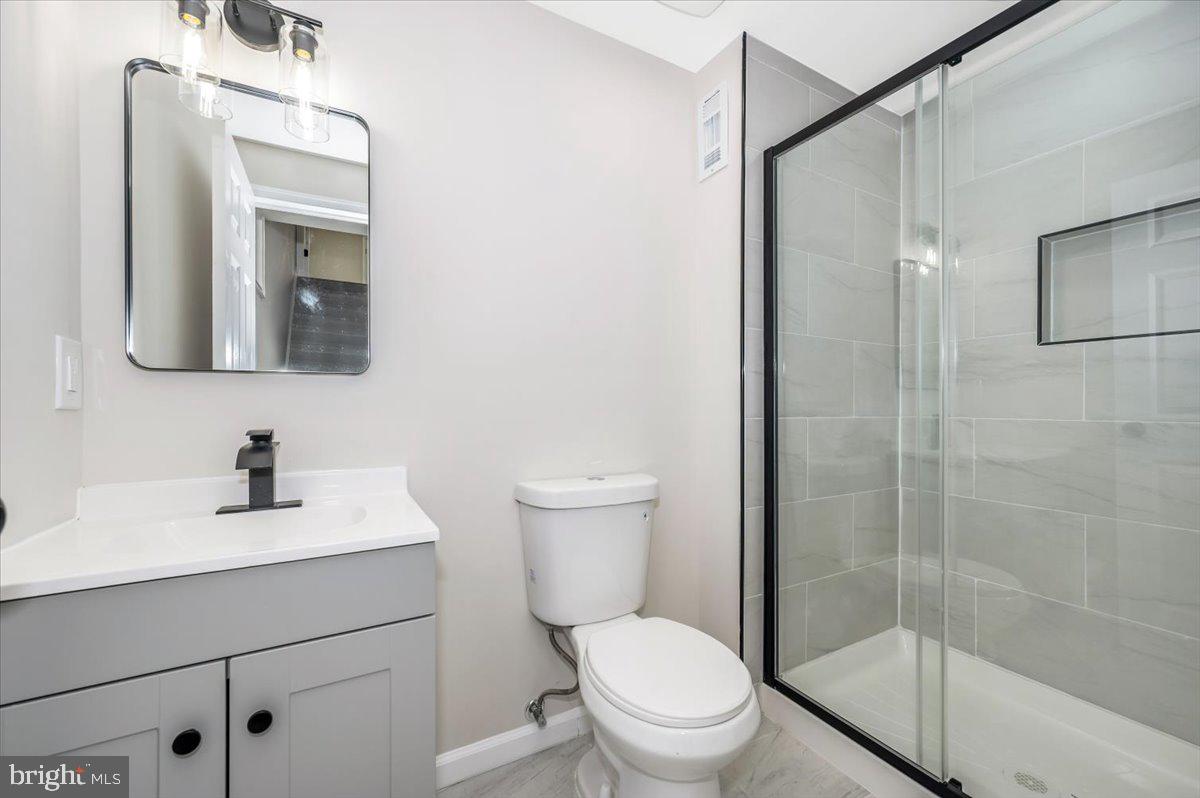 8200 Red Wing Court Frederick, MD 21701 - Photo 32 of 40 a bathroom with a toilet a sink a mirror and vanity