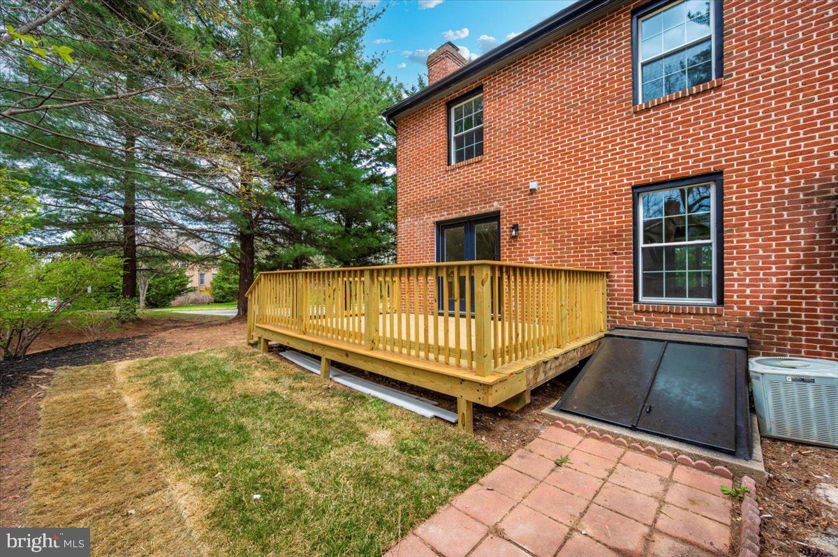 8200 Red Wing Court Frederick, MD 21701 - Photo 37 of 40 a view of a house with a wooden deck and a yard