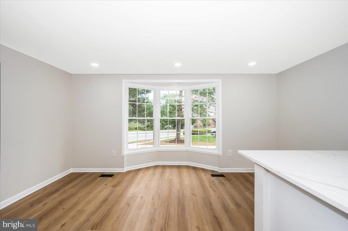 8200 Red Wing Court Frederick, MD 21701 - Photo 4 of 40 a view of an empty room with wooden floor and a window