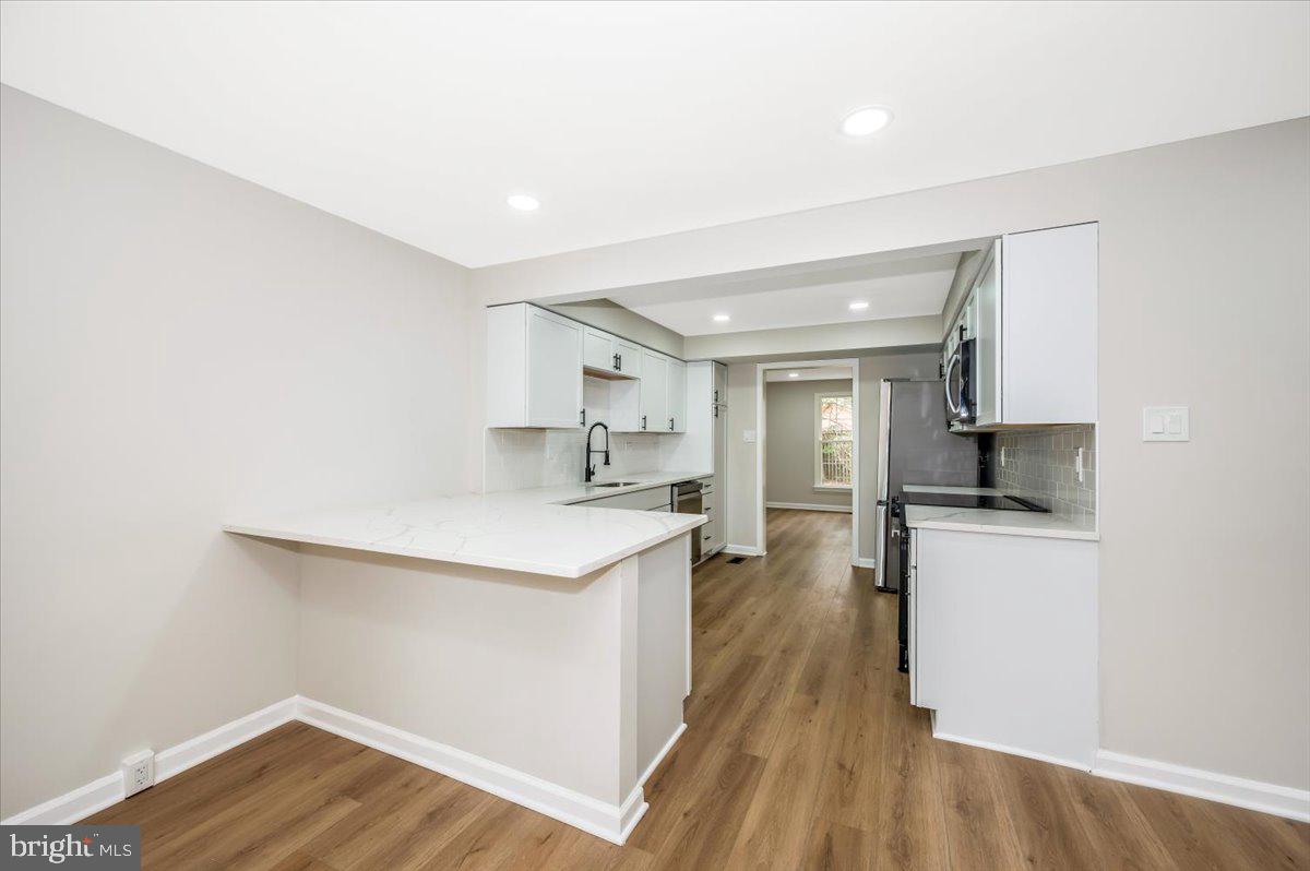 8200 Red Wing Court Frederick, MD 21701 - Photo 6 of 40 a kitchen with a sink a refrigerator and wooden floor