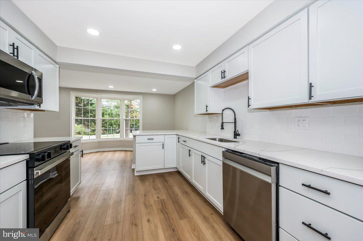 8200 Red Wing Court Frederick, MD 21701 - Photo 8 of 40 a kitchen with a sink a stove and cabinets