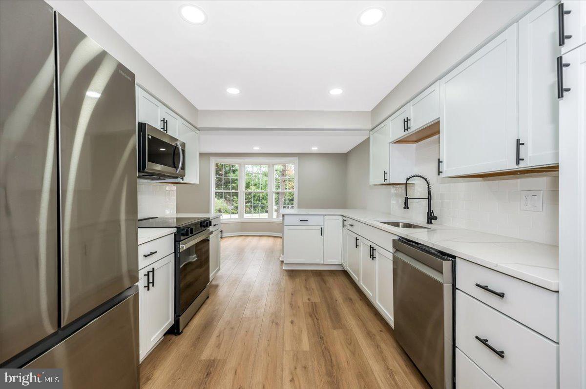 8200 Red Wing Court Frederick, MD 21701 - Photo 9 of 40 a large kitchen with stainless steel appliances granite countertop a lot of counter space and wooden floor