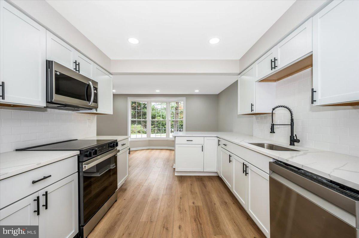 8200 Red Wing Court Frederick, MD 21701 - Photo 10 of 40 a kitchen with a sink wooden floor and stainless steel appliances