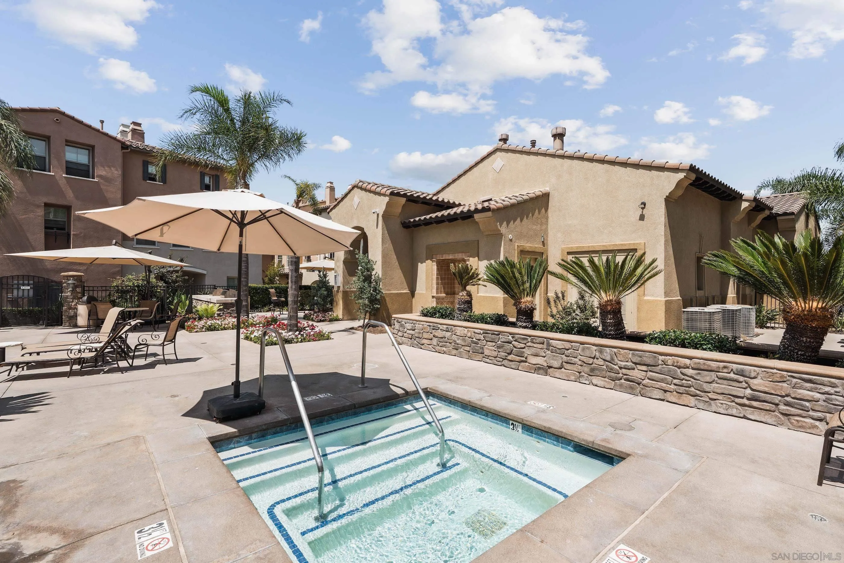 489 Almond Road San Marcos, CA 92078 - Photo 21 of 25 a view of a patio with a table and chairs under an umbrella