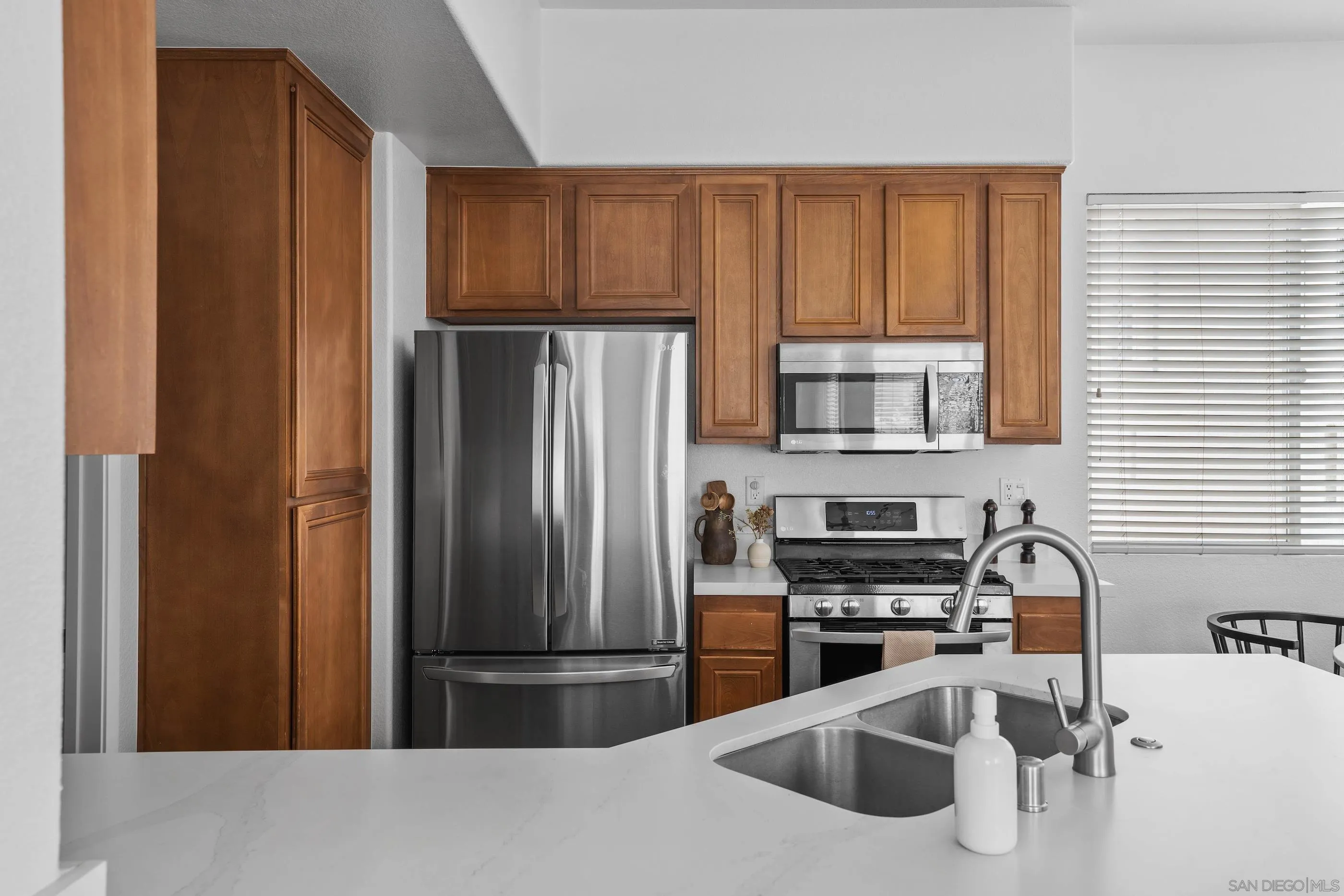 489 Almond Road San Marcos, CA 92078 - Photo 4 of 25 a kitchen with stainless steel appliances granite countertop a refrigerator and a sink