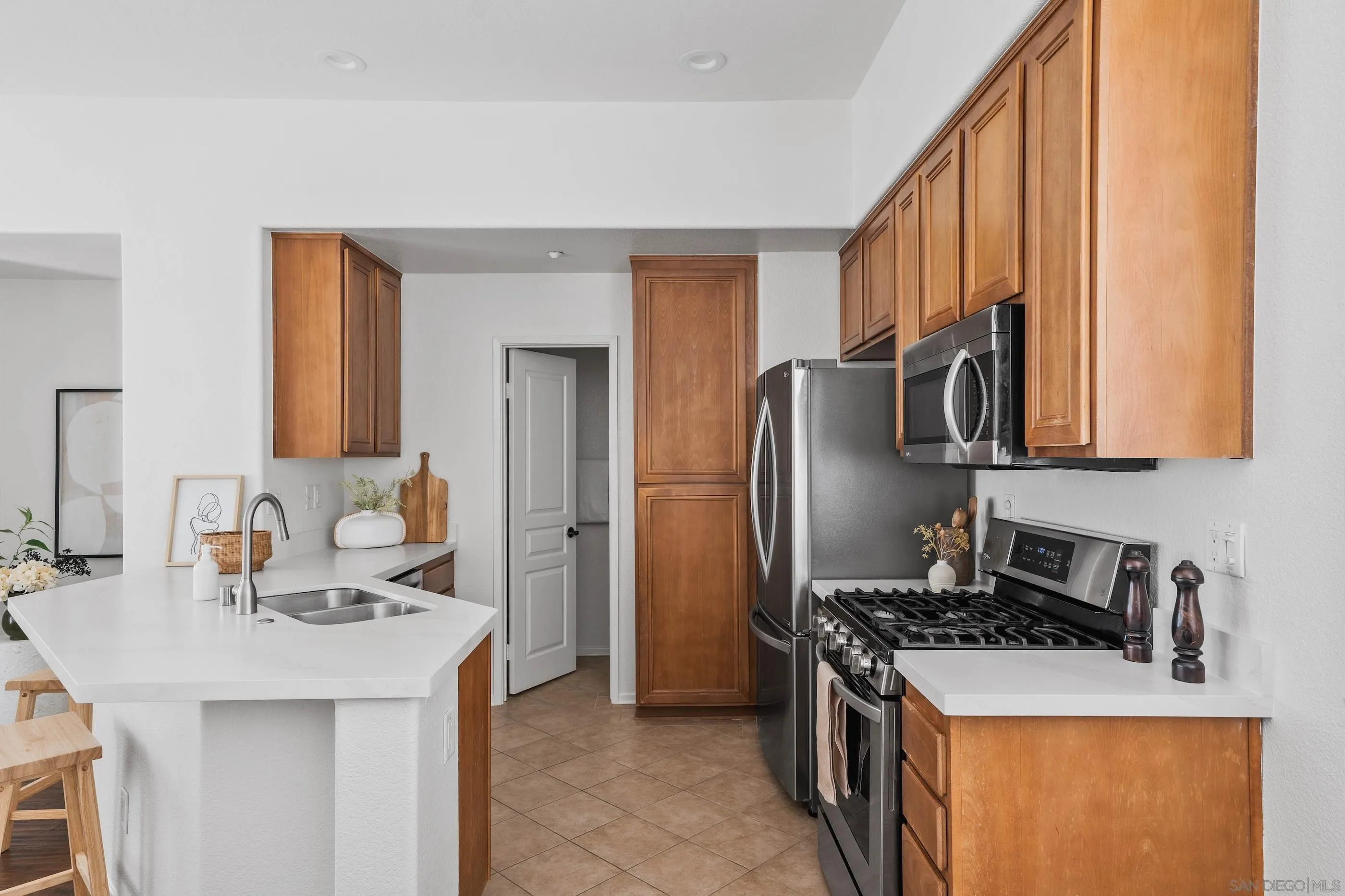 489 Almond Road San Marcos, CA 92078 - Photo 5 of 25 a kitchen with stainless steel appliances granite countertop a sink stove and refrigerator