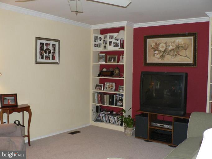 17506 Kohlhoss Road Poolesville, MD 20837 - Photo 7 of 17 Living rom with crown molding and bookshelves