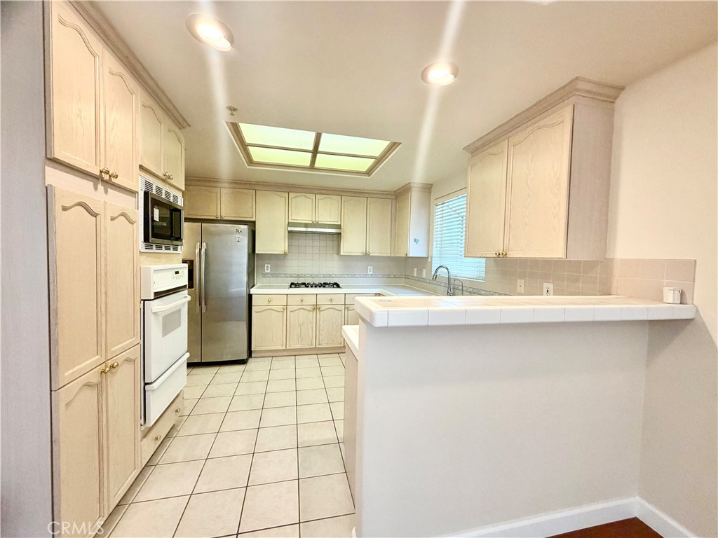 631-ave Fairview, Unit A Arcadia, CA 91006 - Photo 6 of 14 a kitchen with stainless steel appliances a refrigerator sink and cabinets