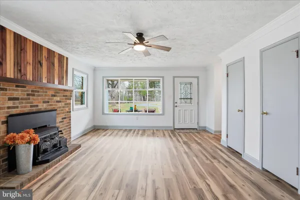 a kitchen with granite countertop a stove a microwave and wooden cabinets