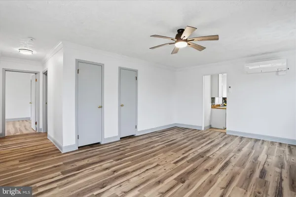 a kitchen with white cabinets and window