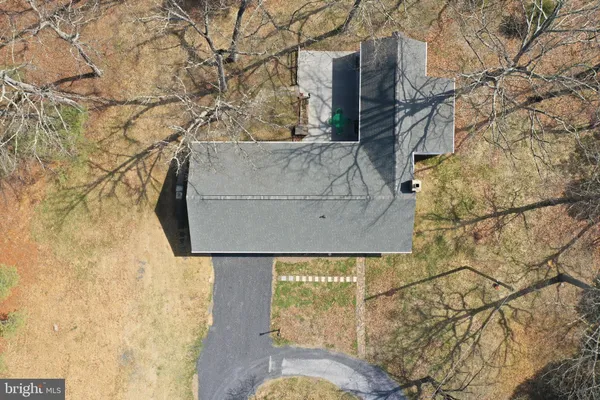 a view of empty room with fireplace and wooden floor
