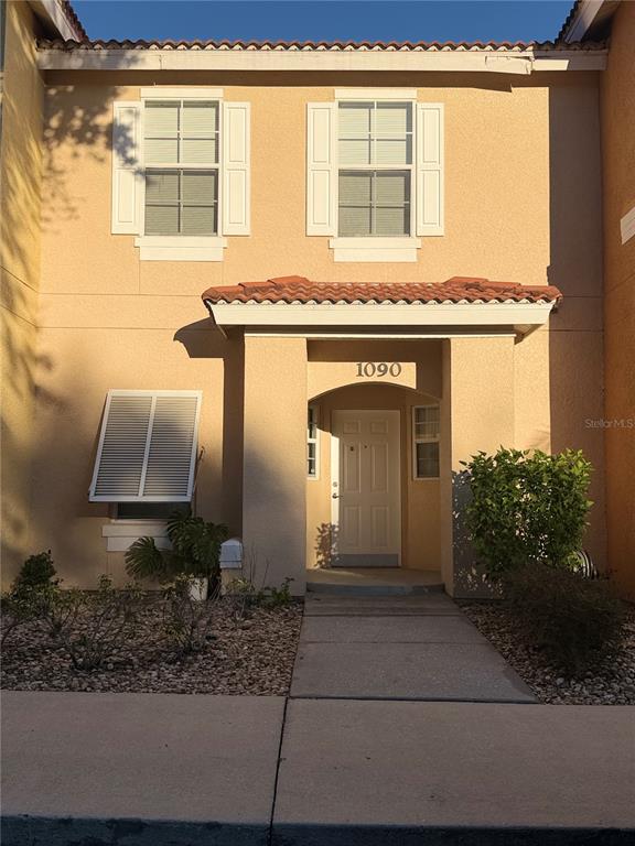 1090 Park Ridge Circle Kissimmee, FL 34746 - Photo 1 of 30 a front view of a house with garden