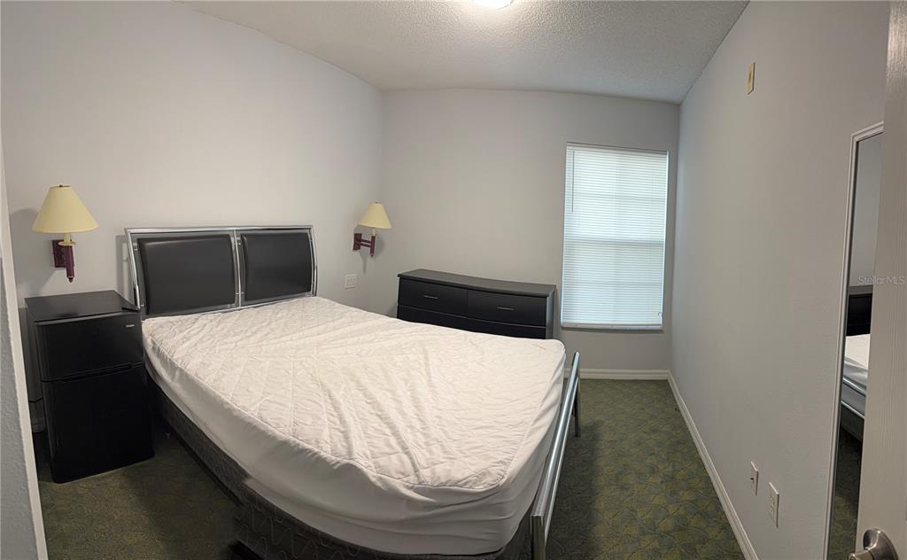 1090 Park Ridge Circle Kissimmee, FL 34746 - Photo 11 of 30 a bedroom with a bed and a night stand