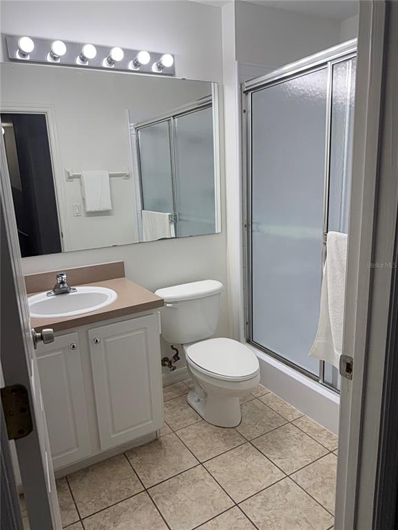 1090 Park Ridge Circle Kissimmee, FL 34746 - Photo 14 of 30 a bathroom with a toilet sink and mirror