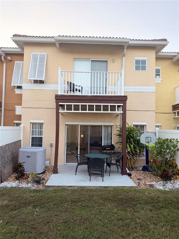 1090 Park Ridge Circle Kissimmee, FL 34746 - Photo 2 of 30 a patio with table and chairs