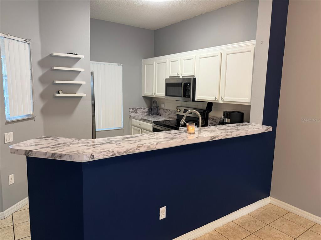 1090 Park Ridge Circle Kissimmee, FL 34746 - Photo 5 of 30 a bathroom with a sink and a mirror