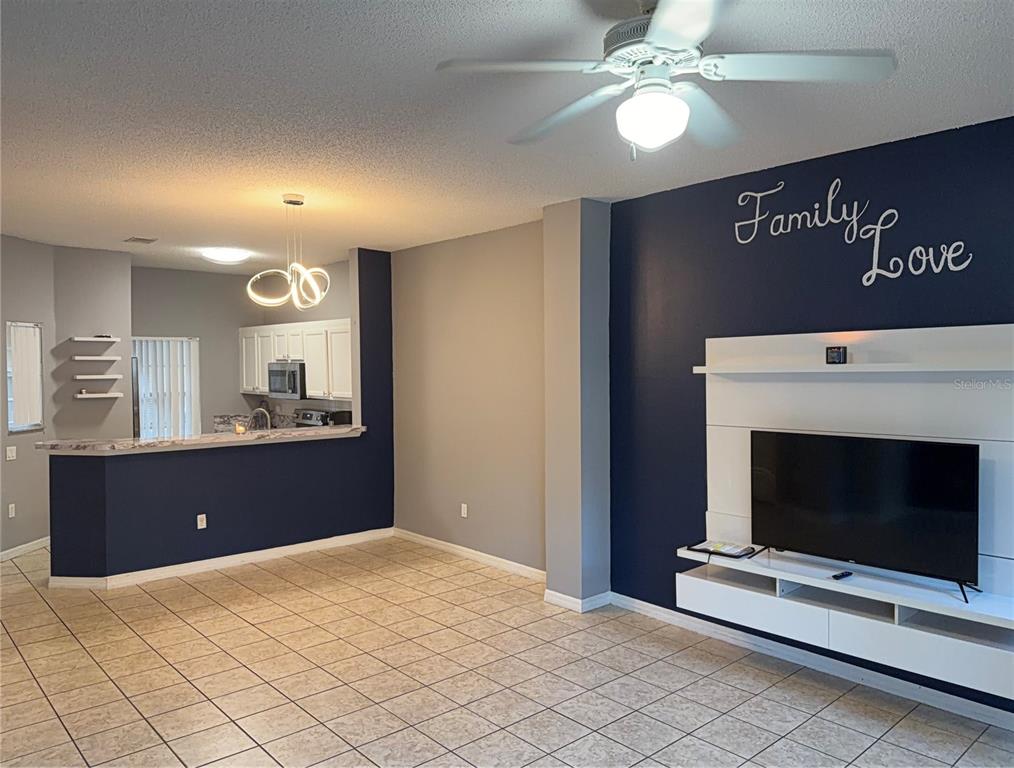 1090 Park Ridge Circle Kissimmee, FL 34746 - Photo 6 of 30 a view of room with window and ceiling fan