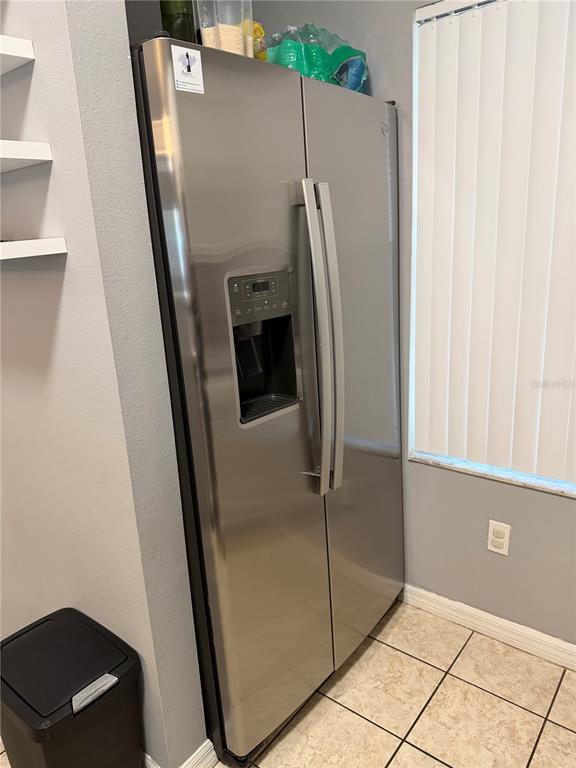 1090 Park Ridge Circle Kissimmee, FL 34746 - Photo 10 of 30 a view of a refrigerator in a kitchen