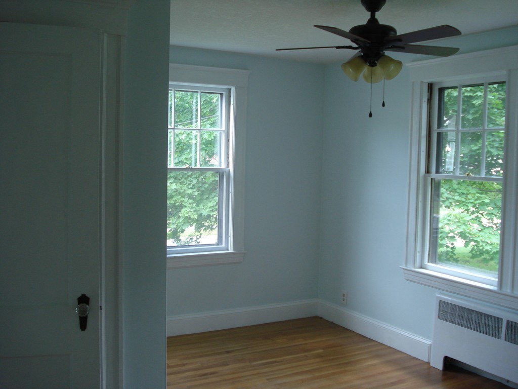 17 Willow Street Wellesley, MA 02481 - Photo 7 of 12 a view of an empty room with a window and wooden floor