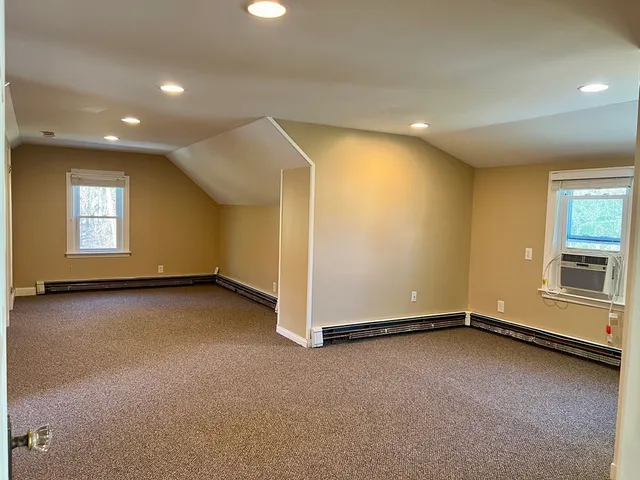 an empty room with windows and closet