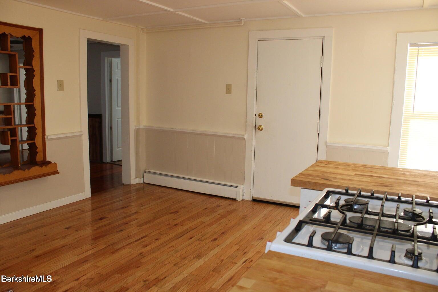3-5 Pleasant Street Pittsfield, MA 01201 - Photo 13 of 22 a room with wooden floor and shoes