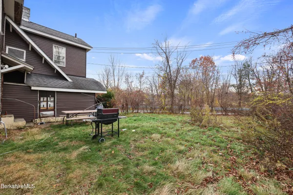 a view of a backyard with sitting area