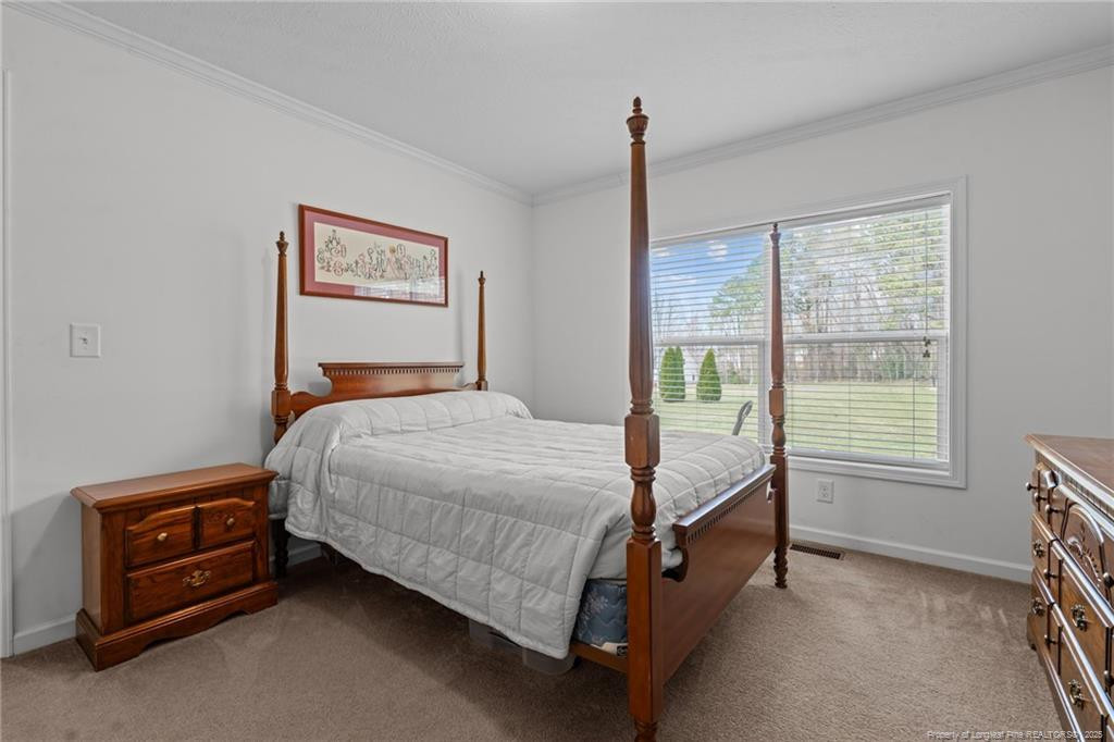 4194 Abattoir Road Angier, NC 27501 - Photo 24 of 50 a bedroom with a bed and a window