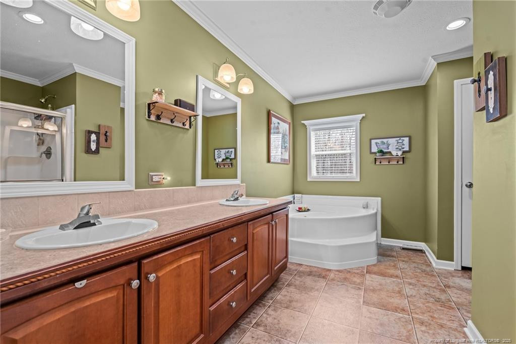 4194 Abattoir Road Angier, NC 27501 - Photo 36 of 50 a bathroom with a granite countertop sink mirror and bathtub