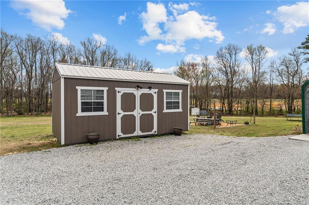 4194 Abattoir Road Angier, NC 27501 - Photo 48 of 50 a view of a house with backyard and trees