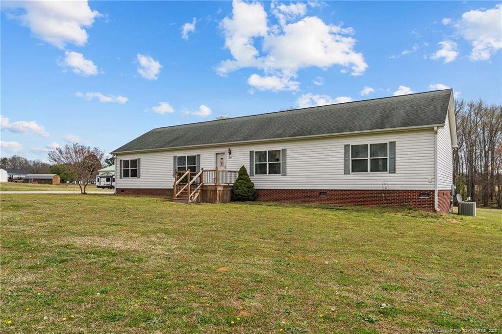 4194 Abattoir Road Angier, NC 27501 - Photo 5 of 50 a front view of house with yard and trees in the background