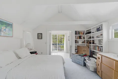 a bedroom with bed furniture and a book shelf