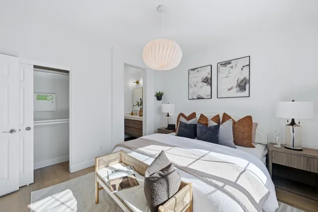 a bedroom with a bed and a night stand