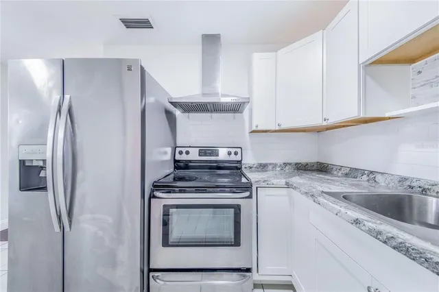 a kitchen with a stove sink and refrigerator