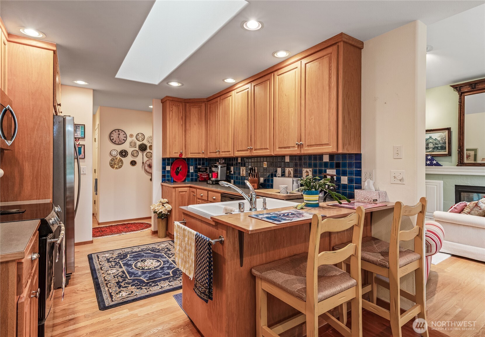 42 Nantucket Place Port Townsend, WA 98368 - Photo 12 of 33 a kitchen with stainless steel appliances granite countertop a stove top oven a refrigerator and cabinets