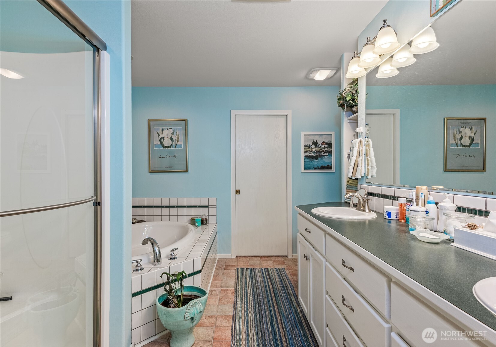 42 Nantucket Place Port Townsend, WA 98368 - Photo 20 of 33 a spacious bathroom with a granite countertop sink a large mirror and a shower