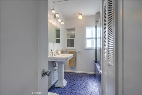 a view of a house with potted plants and large trees