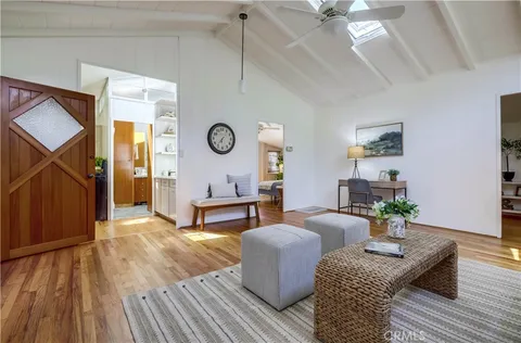 a kitchen with kitchen island granite countertop a stove a sink and a refrigerator