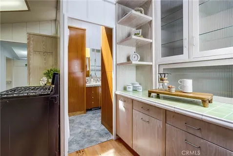 a kitchen with a sink cabinets and wooden floor