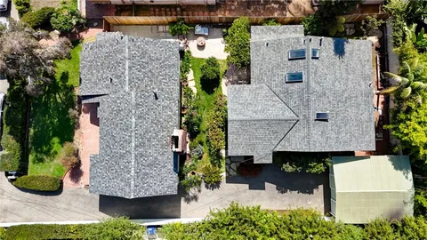 an aerial view of multiple houses with outdoor space