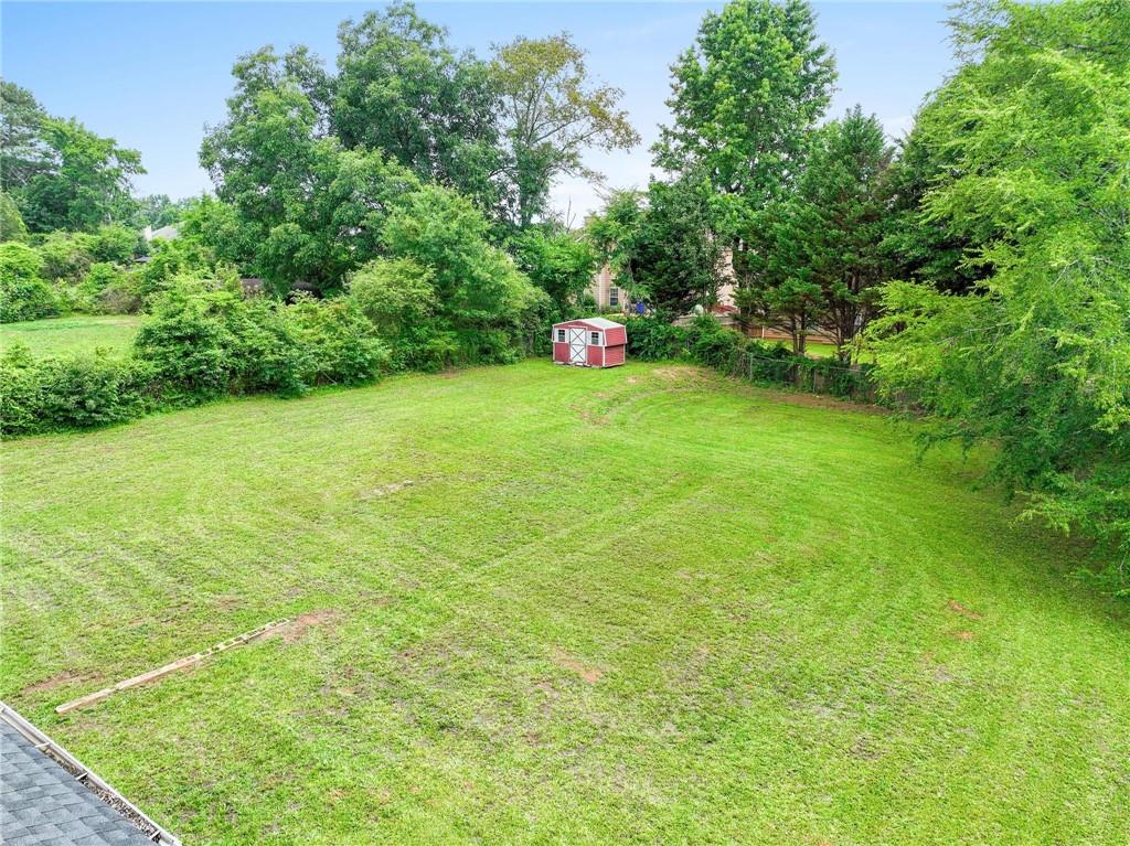 1745 Rockbridge Road Northwest Conyers, GA 30012 - Photo 29 of 32 a green field with lots of trees in it