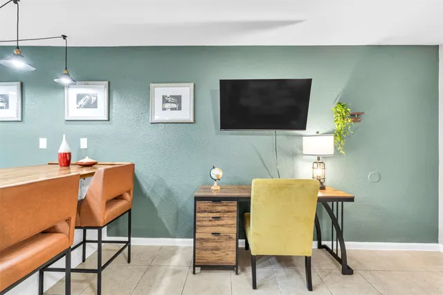 a workspace with furniture and a flat screen tv