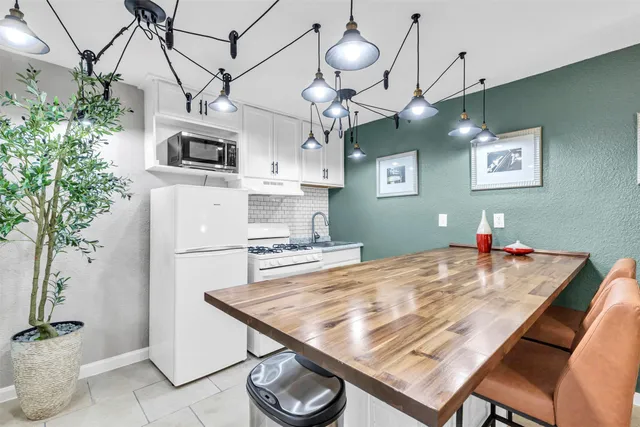 a kitchen with a table and chairs in it
