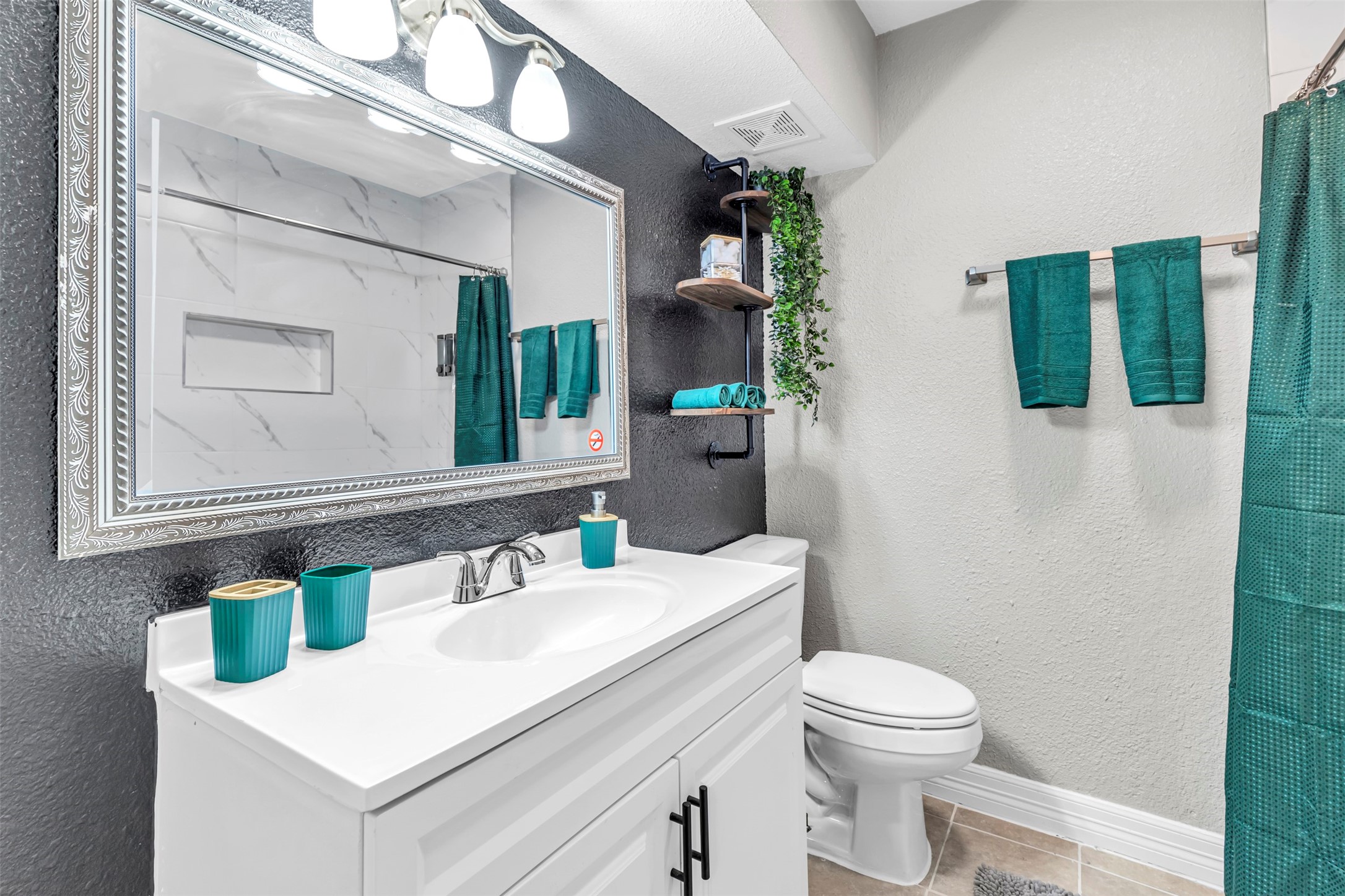 1840 Richmond Avenue, Unit 8 Houston, TX 77098 - Photo 21 of 34 a bathroom with a sink a toilet and mirror